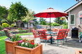 Patio with flower boxes, patio furniture and large red umbrella