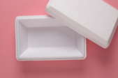 styrofoam cooler on pink background