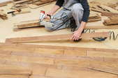 A man installs flooring.