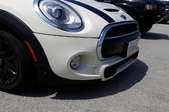 closeup sideview of a white car's bumper