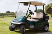A golf cart sitting on the fairway