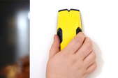 hand using stud finder on wall