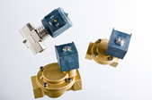 Three solenoid valves isolated on a white background.