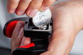 hands screwing camera equipment with coin