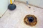 Wax toilet ring on the floor around the toilet drain hole