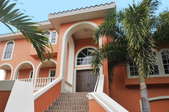 a stucco home near palm trees