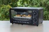 black toaster oven with crossiants inside