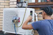 Man repairing an AC unit