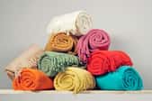 A stack of brightly colored blankets. 
