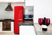 Red fridge and wine glasses in domestic kitchen
