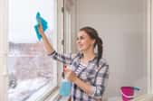 woman cleaning a window