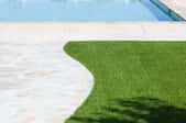 Pathway to a pool with surrounding artificial turf
