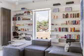 A living room with bookcases around a window. 