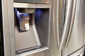 stainless steel fridge with frontal water and ice dispenser