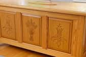 clean light wood cedar chest with carved designs
