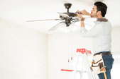 Man working on a ceiling fan