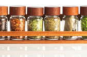 A magnetic spice rack in a kitchen. 