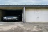 car in a garage with a flat roof