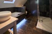 bathroom with polished stone tile floor