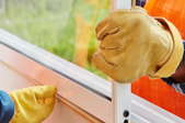 gloved hands installing new window
