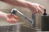 washing hands using kitchen faucet