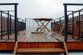 a redwood deck with black railings