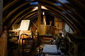 A dimly-lit attic with antique junk.