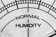 Close-up picture of a humidity meter with arrow far to one side