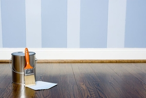 A wall painted in a blue, striped pattern with eggshell paint.