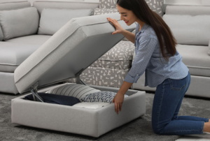 smiling woman opening ottoman with storage inside
