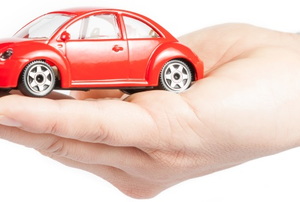 a red toy car in someone's hand