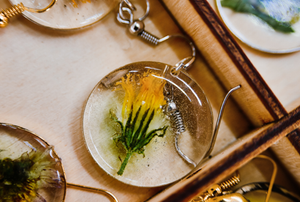 jewelry of a flower encased in a clear circle