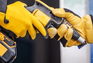 A man uses a drill.