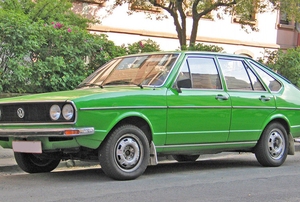 A green car on a road.