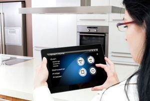 Someone operating a smart kitchen from a tablet.