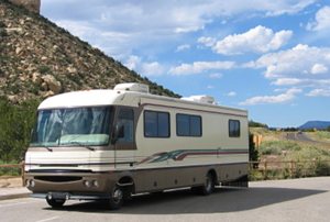 A large motorhome driving along a rural highway.