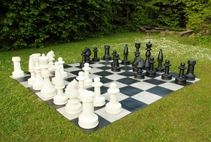 A life-sized backyard chess board in a backyard.