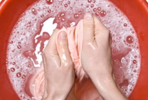Woman washing a shirt in sudsy water