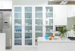 Tall white display cabinet with glass fronts