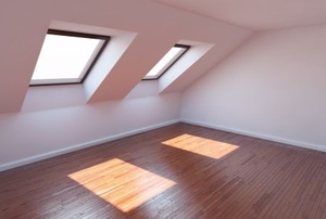 Windows casting patches of light on a wooden attic floor.