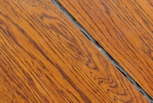 finished wood flooring with a sealed gap between planks