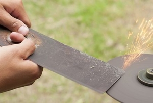 sharpening a damaged lawnmower blade