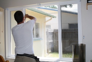A man seals a window.