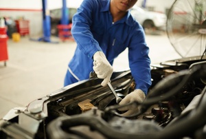 a person in blue working on a car