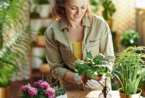 smiling woman holding a plant