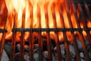 flames rising from a charcoal grill