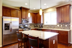 A kitchen with dark wood cabinets.