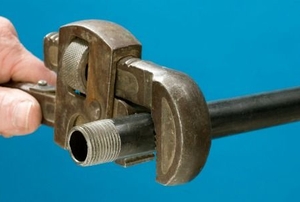 tightening pipe with pipe wrench