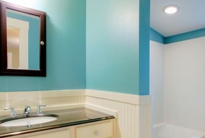 blue walls in bathroom with mirror and sink