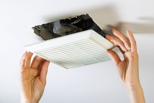 Removing the cover from a ceiling exhaust fan